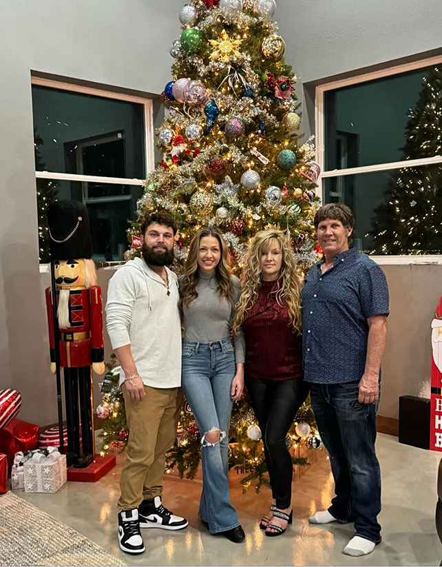 Buddy's Roofing standing in front of a christmas tree